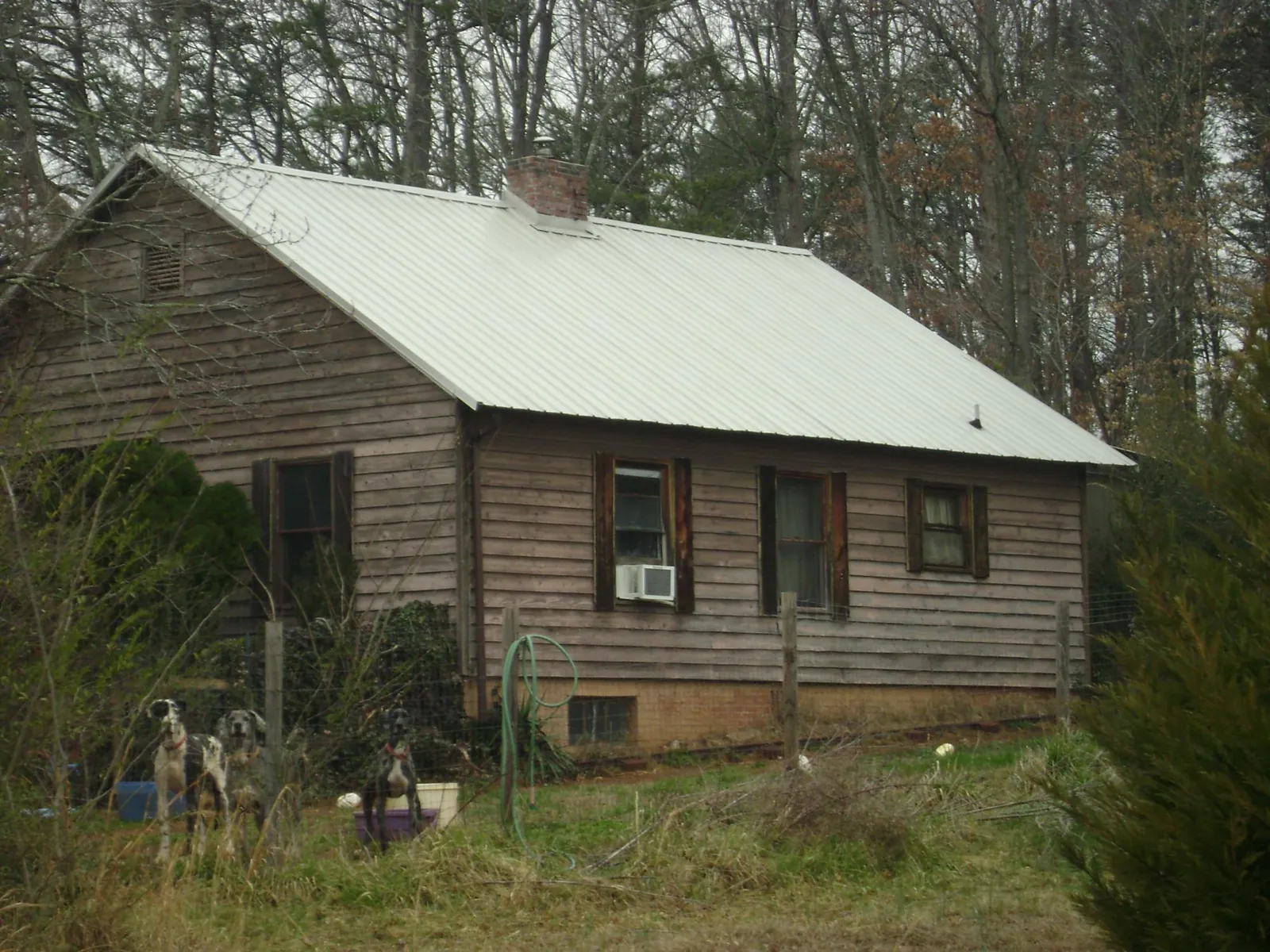 White metal roof on an old wood sided farmhouse, from a Metal Roof Installation job in Coosawhatchie